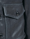 Close-up of a dark gray leather jacket with a buttoned pocket.