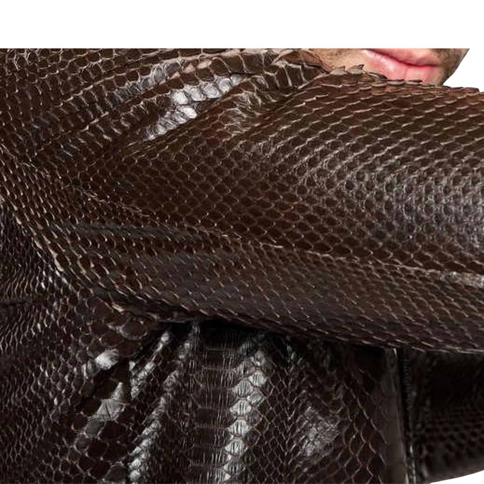 Close-up of a textured brown fabric with a person's face partially visible.