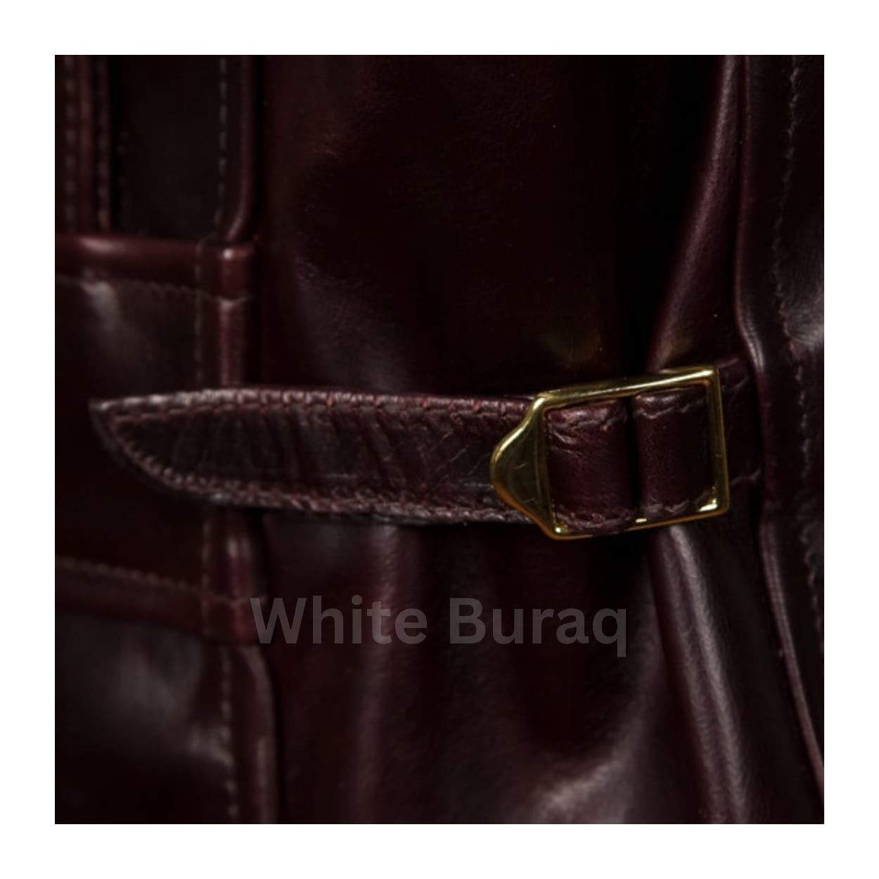 Close-up of a brown leather belt with a gold buckle