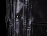 Close-up of a black leather jacket with buttons and stitching details.