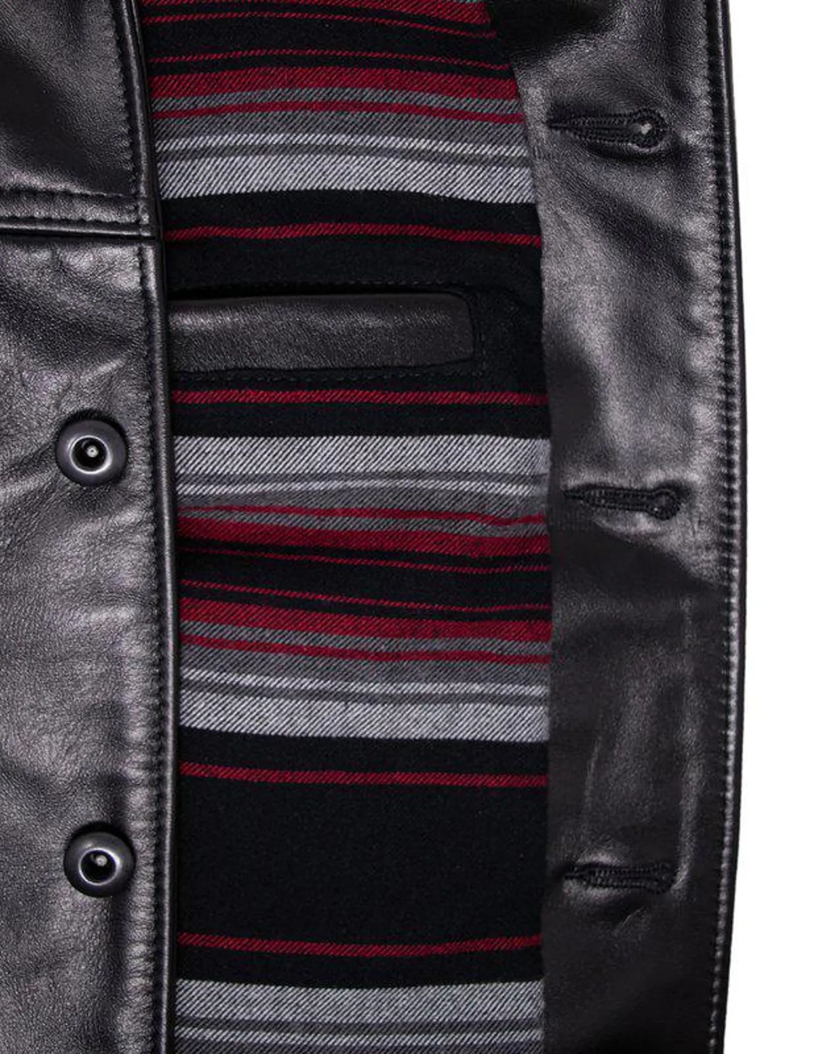 Close-up of a leather jacket with a striped sweater peeking out from underneath.