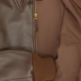 Close-up of a brown leather jacket with a zipper