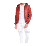 Person wearing a red textured jacket over a white shirt and pants