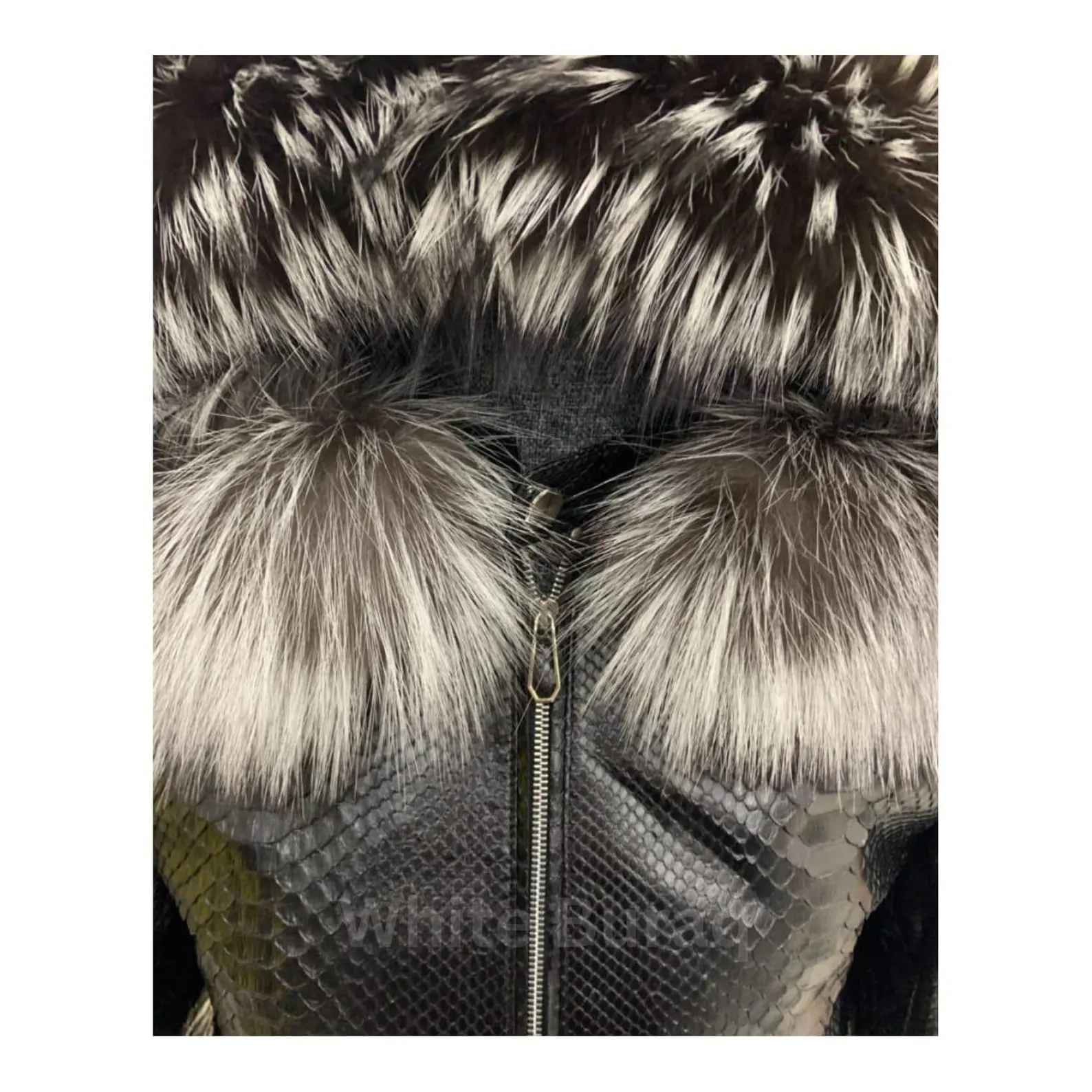 Close-up of a fur-lined hood with a zipper on a textured fabric background