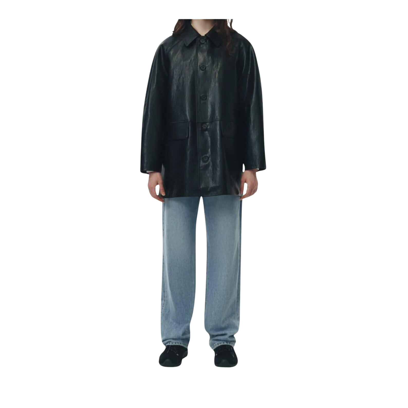 Person wearing a black leather coat and light blue pants