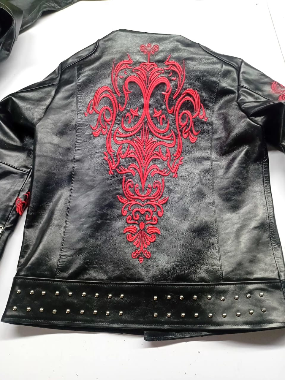 Close-up of red baroque back embroidery and double row of silver studs