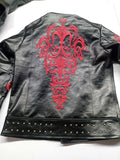 Close-up of red baroque back embroidery and double row of silver studs
