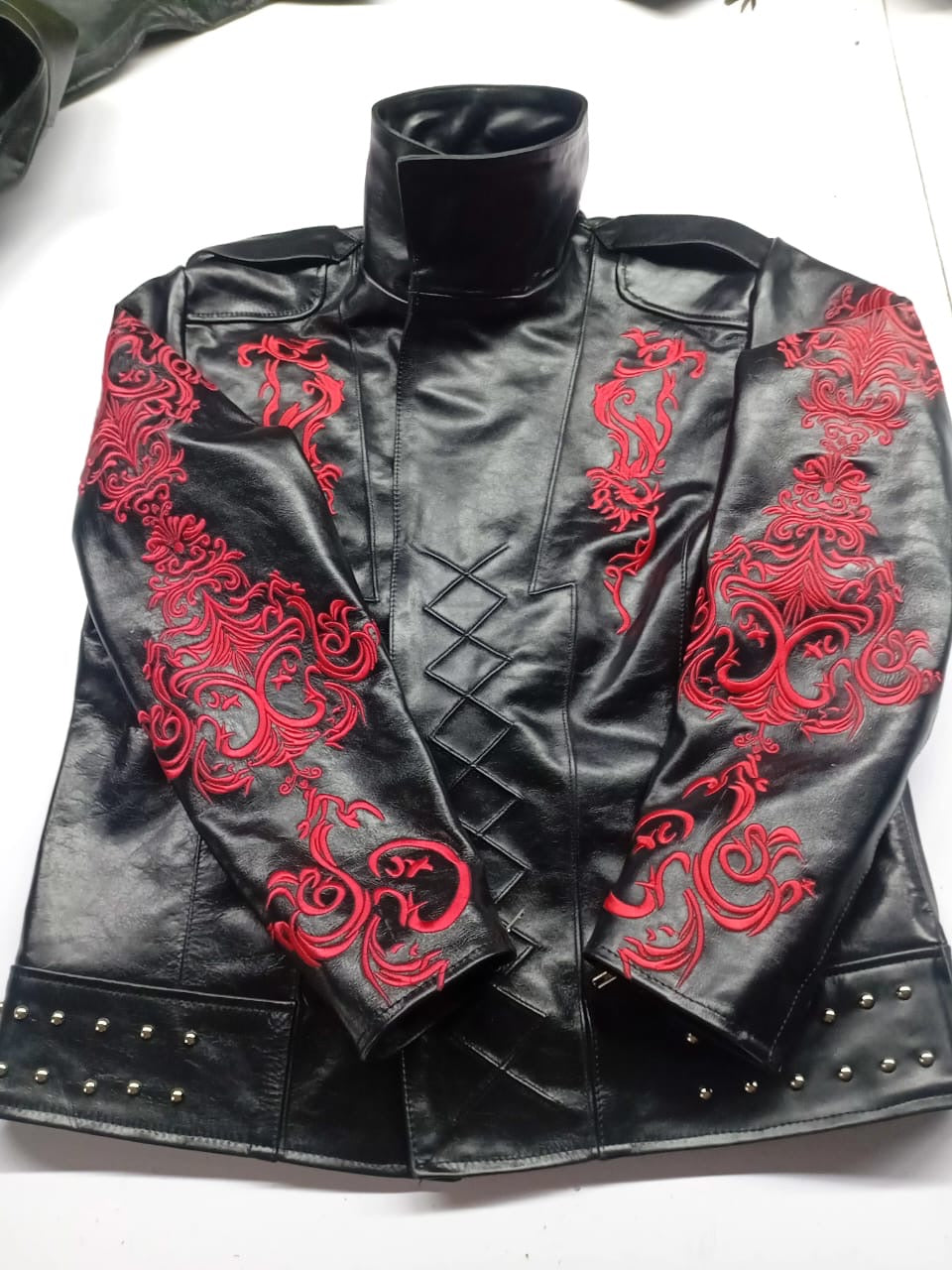 Front of black leather jacket with red dragon embroidery, stand-up collar and lattice-stitched placket