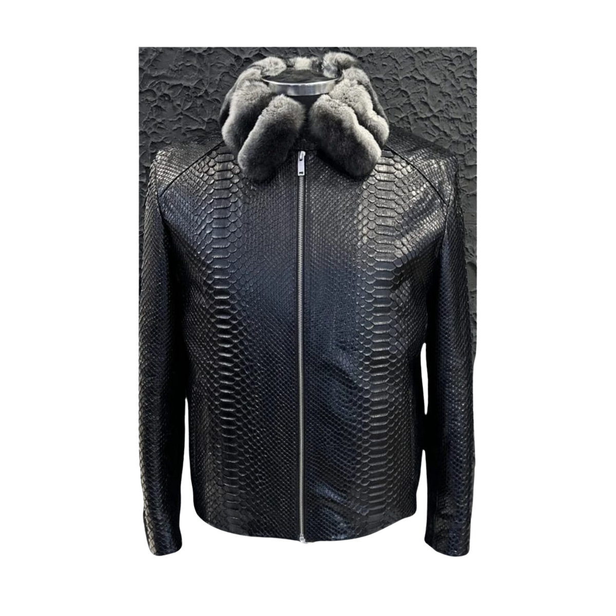 Black textured jacket with fur hood on a textured 