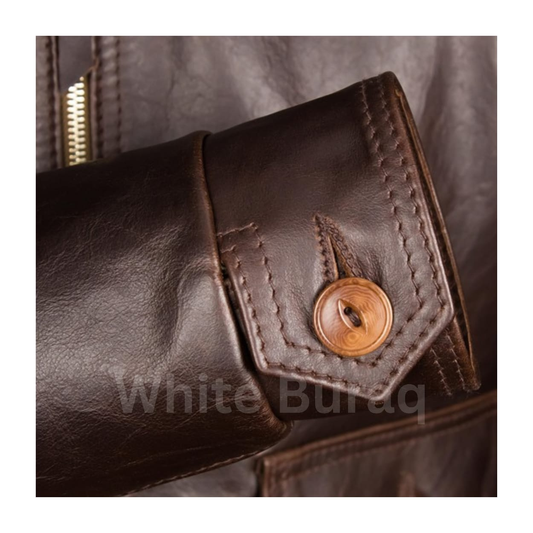 Close-up of a brown leather jacket with a button