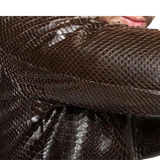 Close-up of a textured brown fabric with a person's face partially visible.