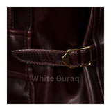 Close-up of a brown leather belt with a gold buckle 