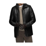 Man wearing a black leather jacket over a beige sweater 
