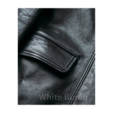 Close-up of a black leather jacket with a pocket,