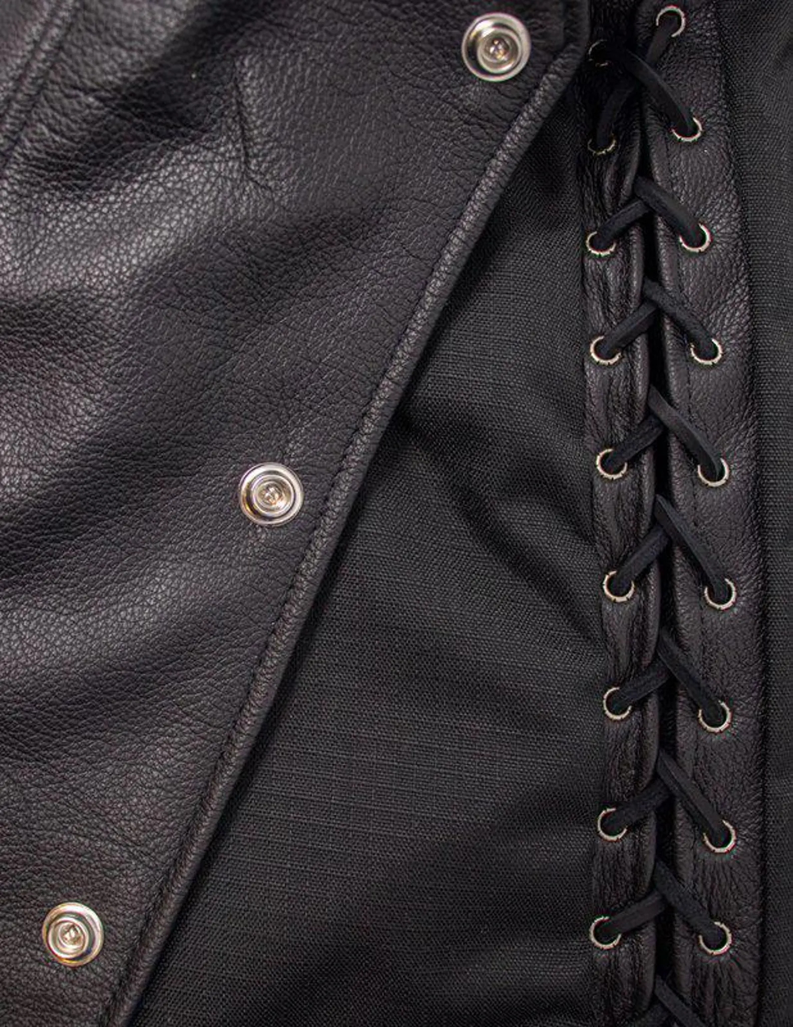 Close-up of a black leather jacket with button details and lace-up front.