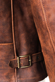 Close-up of a brown leather jacket with a belt buckle.