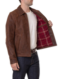 Man wearing a brown leather jacket with a plaid lining, white shirt, and jeans 