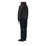 Person wearing a black raincoat and pants 