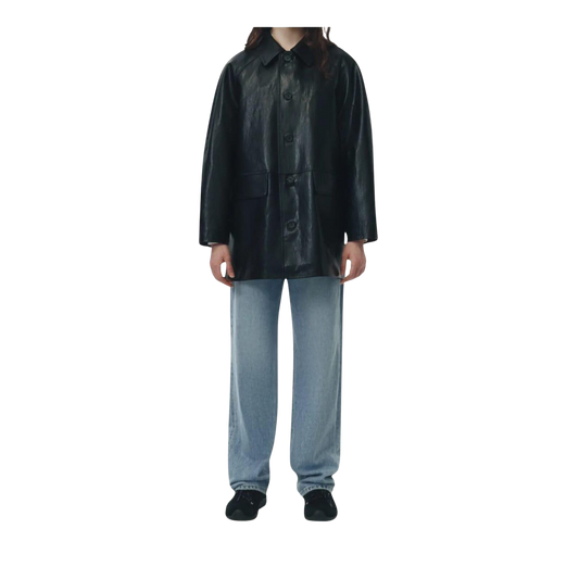 Person wearing a black leather coat and light blue pants 