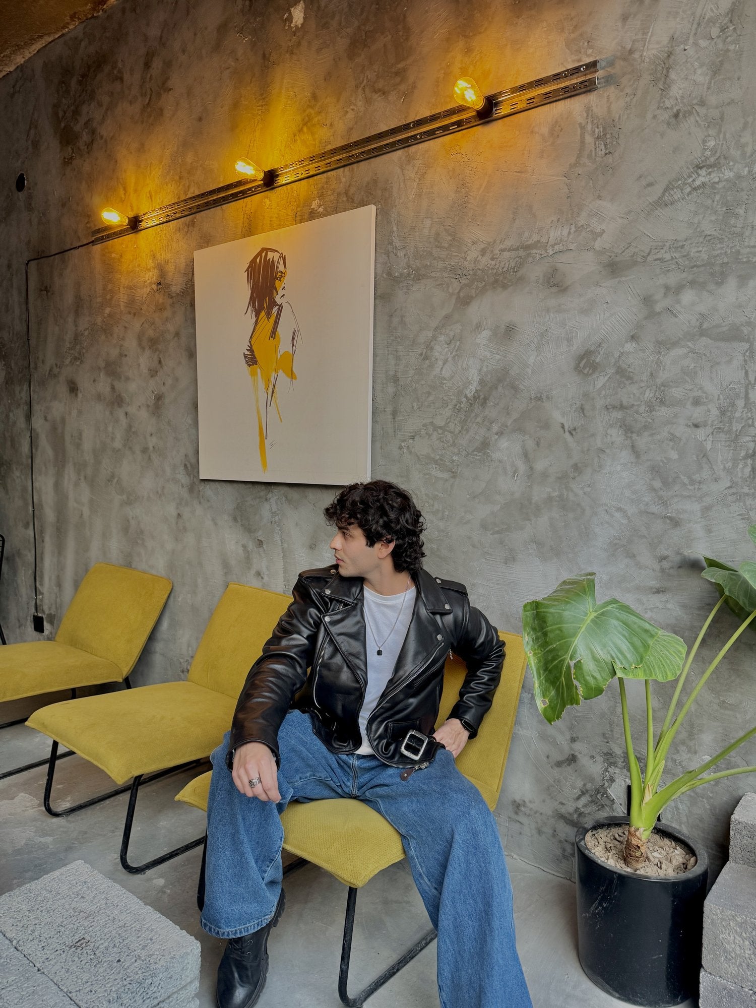 Men's Black Leather Belted Biker Jacket – styled on model, seated